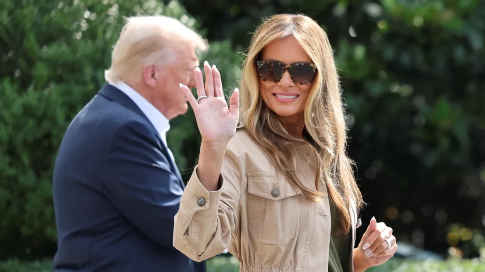 FILE PHOTO: First lady Melania Trump waves as she walks with U.S. President Donald Trump before they depart for travel to Texas to tour areas affected by deadly flash flooding, from the South Lawn of the White House in Washington, D.C., U.S., July 11, 2025. REUTERS/Jonathan Ernst/File Photo