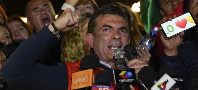 Presidential candidate Rodrigo Paz, center, addresses supporters after early results showed him leading in the presidential election in La Paz, Bolivia, Sunday, Aug. 17, 2025. (AP Photo/Freddy Barragan)