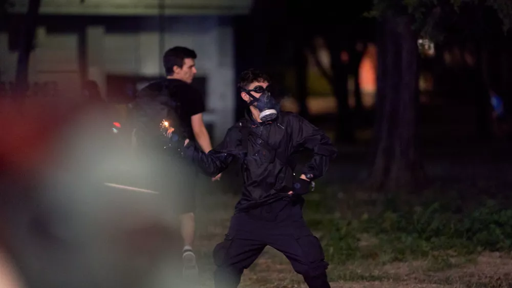 August 16, 2025, Belgrade, Vojvodina province, Serbia: Demonstrators clashed with riot police in Belgrade as tear gas was used during days of anti-government protests. A protester throws a firecracker at a police cordon. (Credit Image: ? Marko Dimic/ZUMA Press Wire)