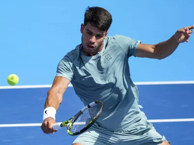 Aug 10, 2025; Cincinnati, OH, USA; Carlos Alcaraz (ESP) returns a shot against Damir Dzumhur (BIH) during the Cincinnati Open at the Lindner Family Tennis Center. Mandatory Credit: Aaron Doster-Imagn Images