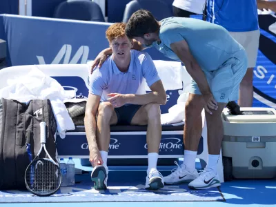 Aug 18, 2025; Cincinnati, OH, USA; Jannik Sinner (ITA), left, talks with Carlos Alcaraz (ESP) after retiring from their match during the Cincinnati Open at the Lindner Family Tennis Center. Mandatory Credit: Aaron Doster-Imagn Images