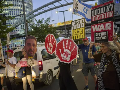 Supporters of Israeli hostages held in the Gaza Strip attend a rally demanding their release from Hamas captivity and calling for an end to the war, in Tel Aviv, Israel, Tuesday, Aug. 19, 2025. (AP Photo/Ohad Zwigenberg)