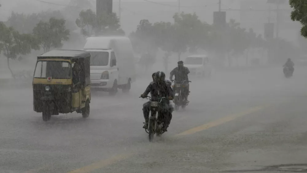 Commuters travel on a road during heavy rain in Karachi, Pakistan, August 20, 2025. REUTERS/Shakil Adil