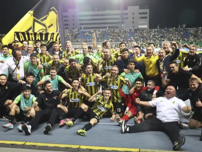 Kairat players celebrate after winning the Champions League playoff second leg soccer match between Kairat and Celtic at Ortalyk stadium in Almaty, Kazakhstan, Wednesday, Aug. 27, 2025. (AP Photo/Alikhan Sariyev)
