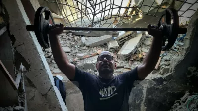 KHAN YUNIS, GAZA - JULY 21: A Palestinian man weightlifts in a gym, which has been damaged due to Israeli attacks, as Palestinian people try to exercise with limited opportunities of bodybuilding equipment in Khan Yunis, Gaza on July 21, 2024. Hani Alshaer / Anadolu,Image: 891889870, License: Rights-managed, Restrictions:, Model Release: no