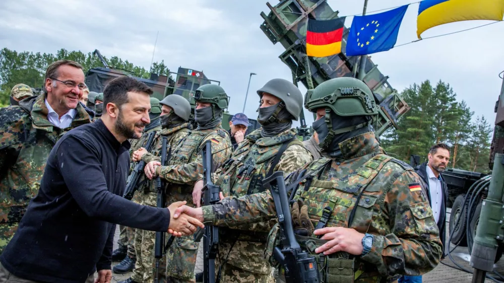 Ukrainian President Volodymyr Zelenskiy interacts with soldiers during his visit to a military training area to find out about the training of Ukrainian soldiers on the ?Patriot? anti-aircraft missile system, at an undisclosed location, in Germany, June 11, 2024.  Jens Buttner/Pool via REUTERS/File Photo