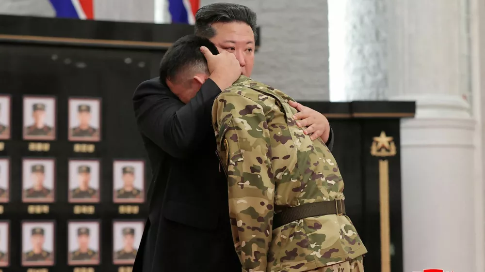 North Korean leader Kim Jong hugs a soldier as he attends a national commendation ceremony for the commanders and fighters of the Korean People's Army's overseas operations unit, at the headquarters of the Central Committee of the Korean Workers' Party, in Pyongyang, North Korea, in this photo released on August 22, 2025 by North Korea's Korean Central News Agency (KCNA). KCNA via REUTERS ATTENTION EDITORS - THIS IMAGE WAS PROVIDED BY A THIRD PARTY. REUTERS IS UNABLE TO INDEPENDENTLY VERIFY THIS IMAGE. NO THIRD PARTY SALES. SOUTH KOREA OUT. NO COMMERCIAL OR EDITORIAL SALES IN SOUTH KOREA.