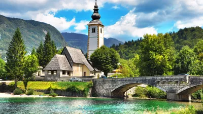 Bohinj Lake, Church of St John the Baptist with bridge. Triglav National Park, Julian Alps, Slovenia.