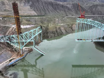 This aerial photo released by Xinhua News Agency shows the site of an under construction bridge that collapsed on the Qinghai section of the Sichuan-Qinghai Railway causing multiple dead and missing, in northwest China's Qinghai Province on Friday, Aug. 22, 2025. (Li Zhanyi/Xinhua via AP)