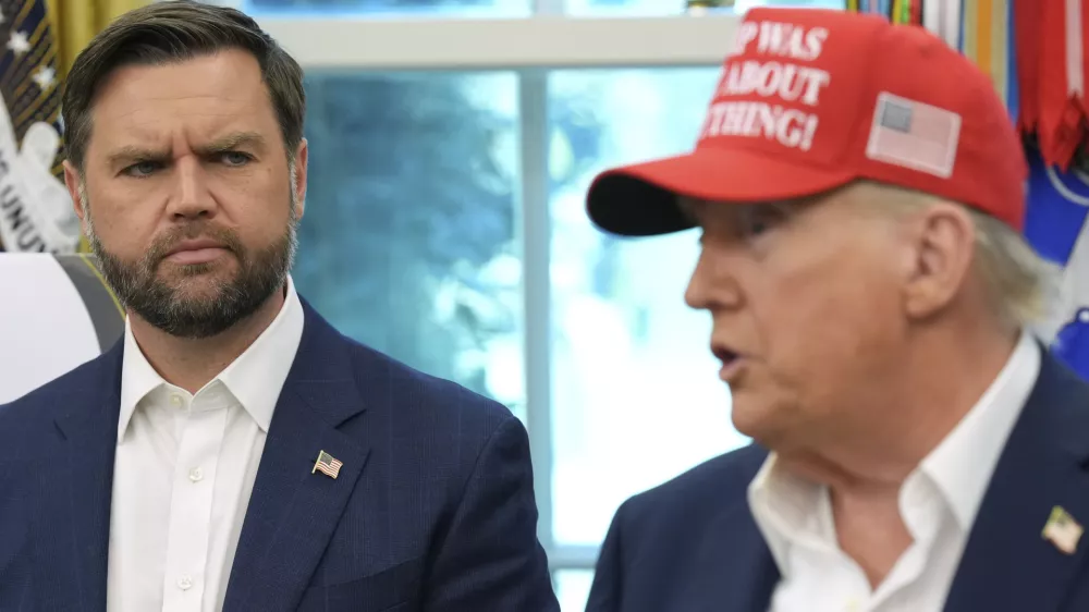 Vice President JD Vance looks on as President Donald Trump speaks in the Oval Office of the White House, Friday, Aug. 22, 2025, in Washington. (AP Photo/Jacquelyn Martin)