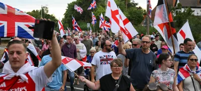 Protesters take part in an anti-immigration demonstration, following Tuesday's High Court ruling in London that granted a temporary injunction to stop asylum seekers from being housed at the The Bell Hotel, in Epping, Britain, August 24, 2025. REUTERS/Jaimi Joy