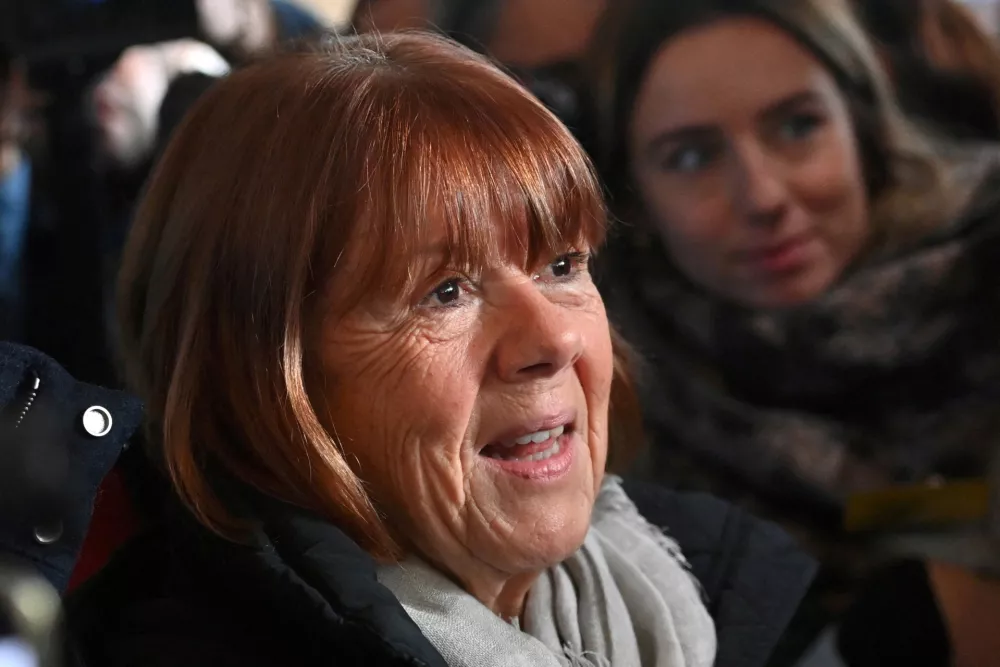 FILE PHOTO: Frenchwoman Gisele Pelicot, the victim of an alleged mass rape orchestrated by her then-husband Dominique Pelicot at their home in the southern French town of Mazan, leaves after a hearing in the trial for Dominique Pelicot and 50 co-accused, at the courthouse in Avignon, France, December 16, 2024. REUTERS/Alexandre Dimou/File Photo