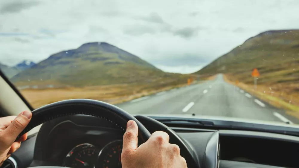 PYTTDD travel, driving car on a beautiful scenic road in Iceland