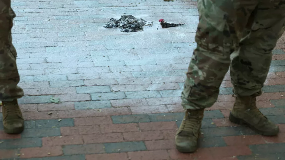 U.S. Army National Guard soldiers stand at the scene where a man burned a U.S. flag at the edge of Lafayette Park across from the White House in Washington, D.C., U.S., August 25, 2025. REUTERS/Jonathan Ernst