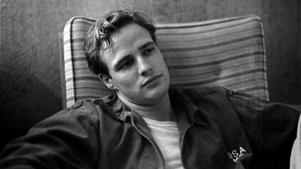 Marlon Brando, sitting on the porch, during the filming of"The Men".