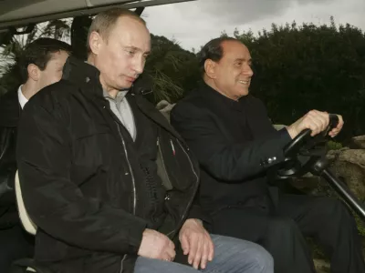 Russia's President Vladimir Putin (L) rides on a golf cart with Italy's Prime Minister-elect Silvio Berlusconi at Berlusconi's Sardinian private summer residence villa "La Certosa" in Porto Rotondo village April 17, 2008. Putin arrived for an overnight private visit on his return from Libya. Picture taken April 17, 2008. REUTERS/Livio Anticoli-People of Freedom party/ Handout (ITALY). FOR EDITORIAL USE ONLY. NOT FOR SALE FOR MARKETING OR ADVERTISING CAMPAIGNS.