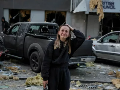 A woman reacts near a building housing the local branch of the British Council, as she stands at the site of an apartment building hit during Russian drone and missile strikes, amid Russia's attack on Ukraine, in Kyiv, Ukraine August 28, 2025. REUTERS/Stringer   TPX IMAGES OF THE DAY