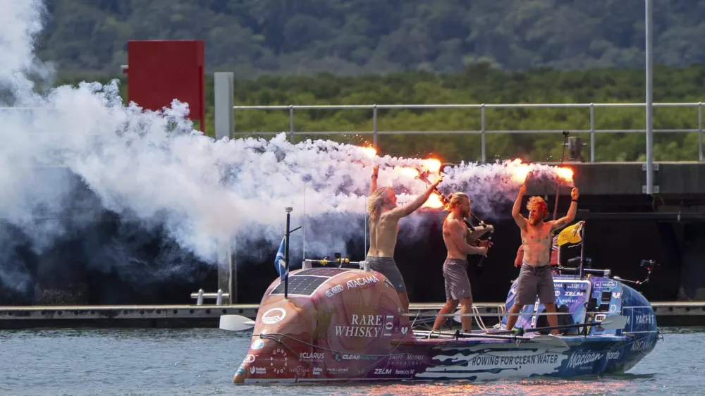 Scottish brothers, Ewan, Jamie and Lachlan, Maclean react after completing their record breaking row from Peru across the Pacific Ocean to Cairns, Australia, Saturday, Aug. 30, 2025. (Nuno Avendano/AAP Image via AP)