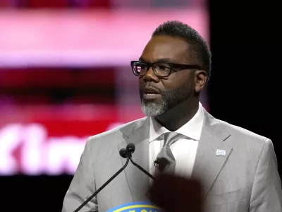A member of the audience raises their fist as Chicago Mayor Brandon Johnson delivers his inaugural address Monday, May 15, 2023, in Chicago. (AP Photo/Charles Rex Arbogast)