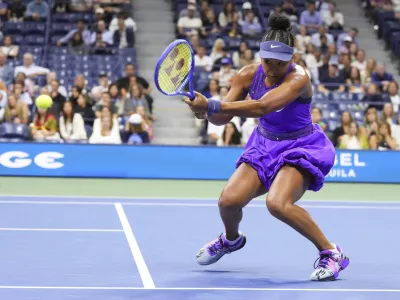 Naomi Osaka, of Japan, returns a shot to Amanda Anisimova, of the United States, during the women's singles semifinals of the U.S. Open tennis championships, Thursday, Sept. 4, 2025, in New York. (AP Photo/Kirsty Wigglesworth)