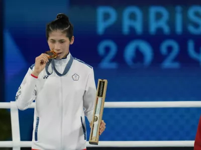 Gold medalist Taiwan's Lin Yu-ting poses during a medals ceremony for the women's 57 kg final boxing match at the 2024 Summer Olympics, Saturday, Aug. 10, 2024, in Paris, France. (AP Photo/Ariana Cubillos)