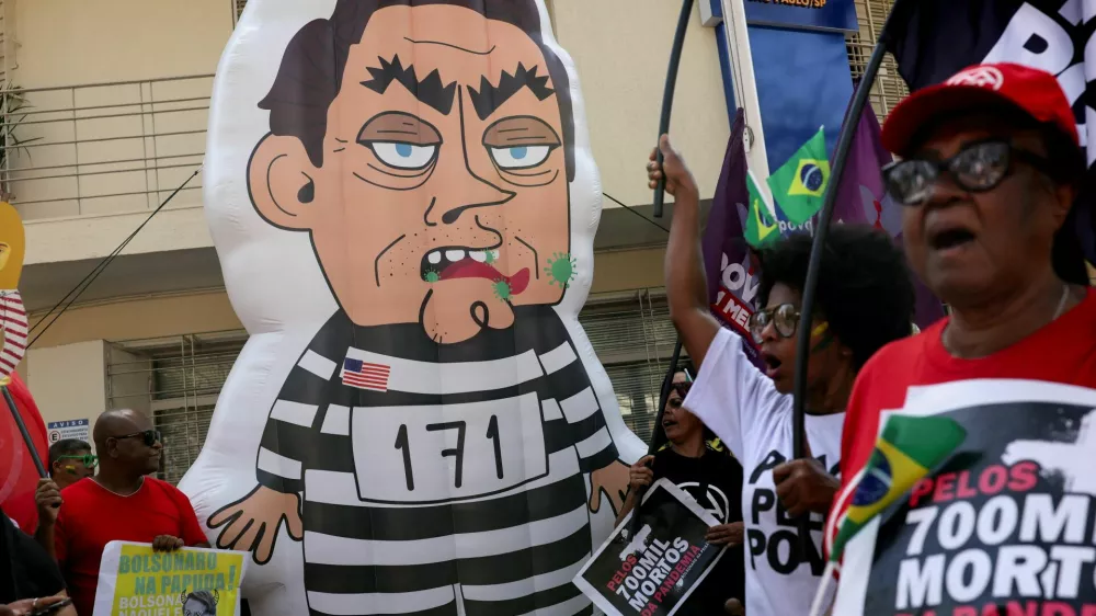 An inflatable figure depicting Brazil's former President Jair Bolsonaro stands near protesters during a demonstration outside the PL party headquarters on the final phase of Bolsonaro's trial, in which he is accused of plotting a coup after his electoral defeat, in Sao Paulo, Brazil, September 2, 2025. REUTERS/Amanda Perobelli REFILE - CORRECTING INFORMATION FROM "THE FINAL DAY OF HIS TRIAL" TO "THE FINAL PHASE OF HIS TRIAL / Foto: Amanda Perobelli