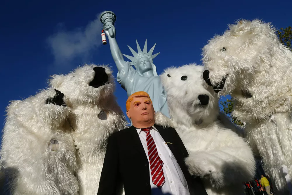 ﻿A protester wearing a mask of U.S. President Donald Trump stand along with other protesters dressed as polar bears during a demonstration under the banner "Protect the climate - stop coal" two days before the start of the COP 23 UN Climate Change Conference hosted by Fiji but held in Bonn, Germany November 4, 2017. REUTERS/Wolfgang Rattay   TPX IMAGES OF THE DAY