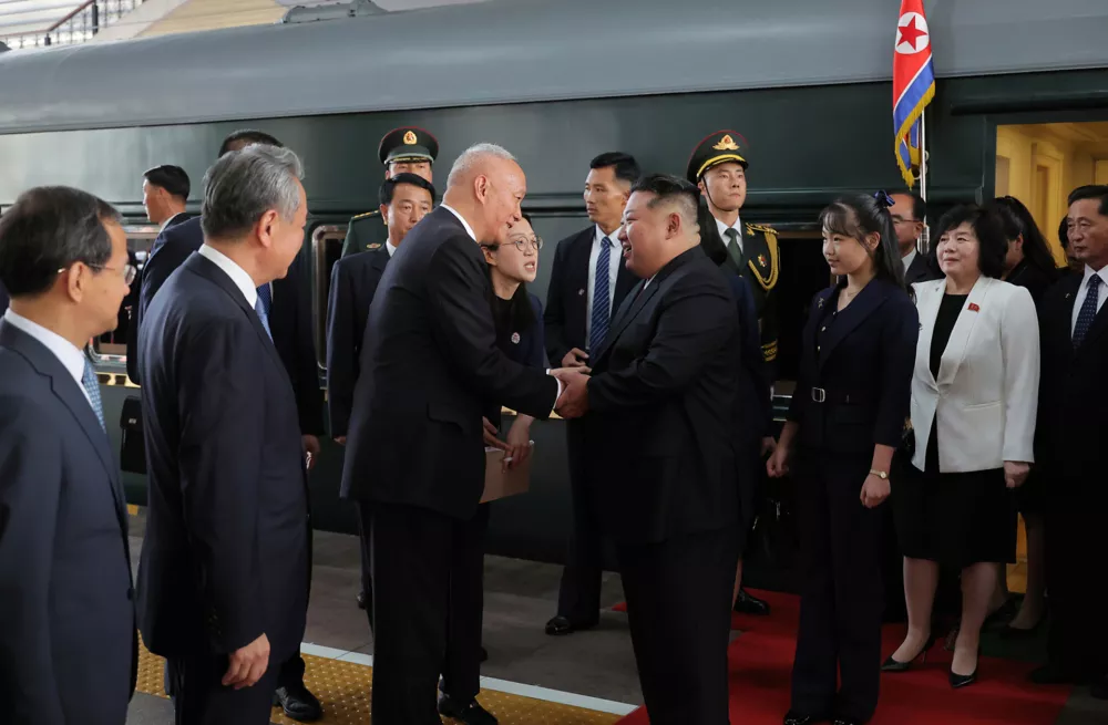 This photo provided by the North Korean government, North Korean leader Kim Jong Un, center right, is greeted by China's Senior Politburo Standing Committee member Cai Qi, center left, on his arrival at a station in Beijing, China, Tuesday, Sept. 2, 2025. Independent journalists were not given access to cover the event depicted in this image distributed by the North Korean government. The content of this image is as provided and cannot be independently verified. (Korean Central News Agency/Korea News Service via AP)