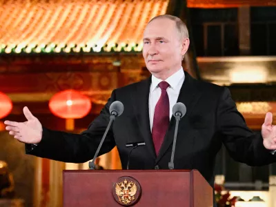Russian President Vladimir Putin gestures during a press conference, at the end of his visit to China for the Tianjin SCO Summit and the military parade to mark the 80th anniversary of the end of World War Two, in Beijing, China, Wednesday, Sept. 3, 2025. (Sergei Bobylev, Sputnik, Kremlin Pool Photo via AP)