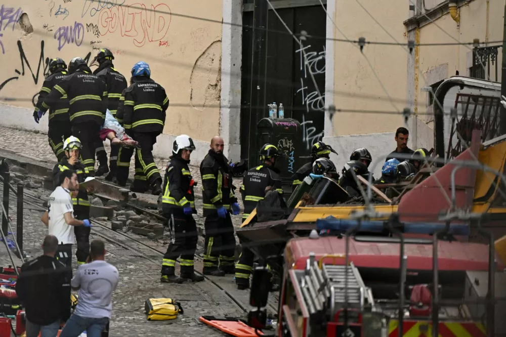 First responders work at the site of an accident involving Lisbon's Gloria funicular, a popular tourist attraction, which derailed and crashed, resulting in fatalities and injuries, according to authorities, in Lisbon, Portugal, September 3, 2025. REUTERS/Stringer