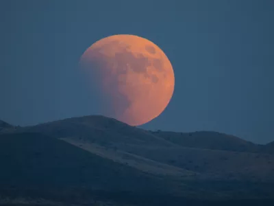 Super-blood moon rises over the Dragoon Mountains as viewed from Tombstone, Arizona