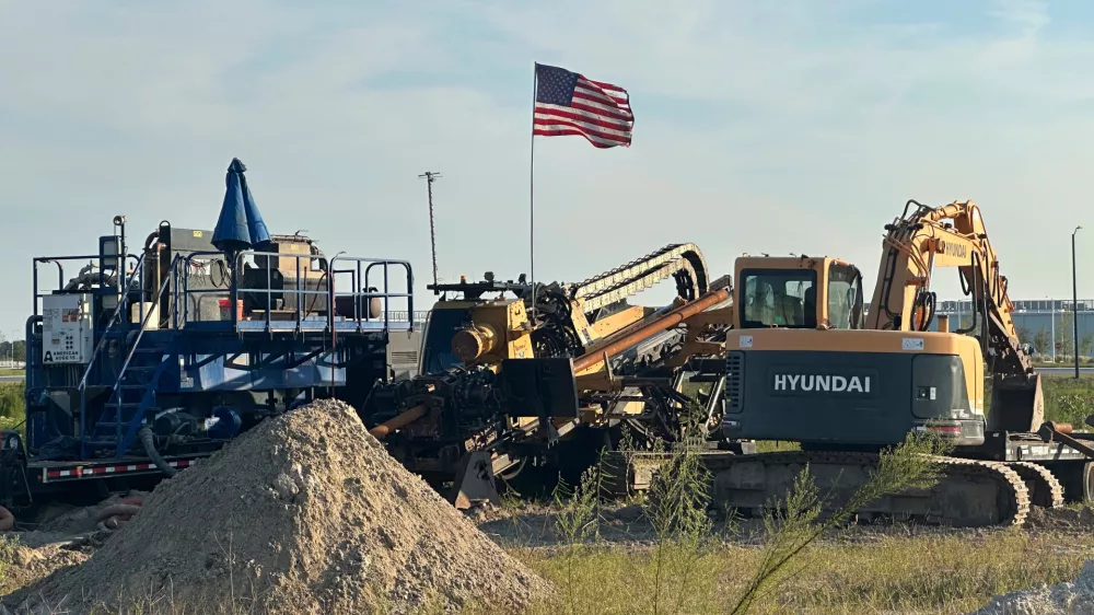 An American flag flies above a piece of heavy machinery at the site of Hyundai Motor Group's electric vehicle plant in Ellabell, Georgia, Friday, Sept. 5, 2025. (AP Photo/Russ Bynum)