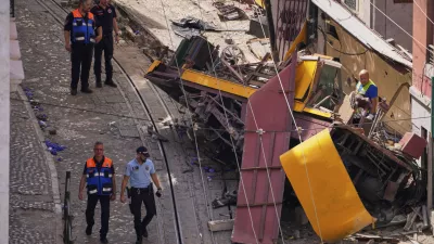 Police officers inspect the site where a tourist streetcar derailed and crashed in Lisbon, Portugal, Thursday, Sept. 4, 2025. (AP Photo/Armando Franca)