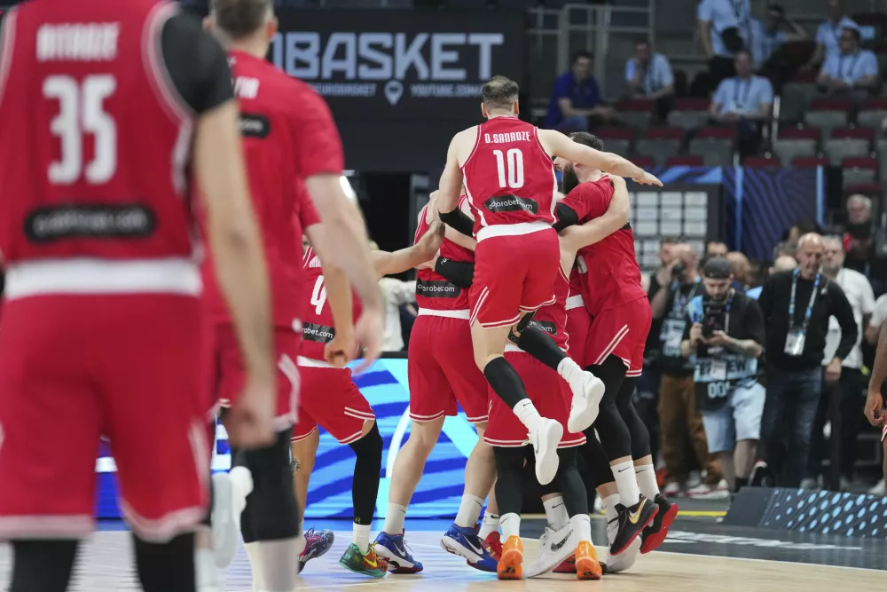 Georgia players celebrate their victory after the Eurobasket, European Basketball Championship round of 16 match between France and Georgia at the Riga Arena in Riga, Latvia, Sunday, Sept. 7, 2025. (AP Photo/Sergei Grits)