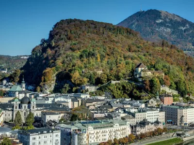 Dvorec Paschinger Schlossl, ki ga je obnovil Porsche, je skrit v zelenju hriba Kapuzinerberg, levo od bolje videnega gradu na desnem delu fotografije. Foto: Profimedia 