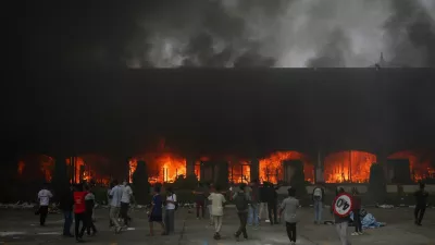A fire burns inside the Parliament complex during a protest against Monday's killing of 19 people after anti-corruption protests that were triggered by a social media ban, which was later lifted, during a curfew in Kathmandu, Nepal, September 9, 2025. REUTERS/Adnan Abidi