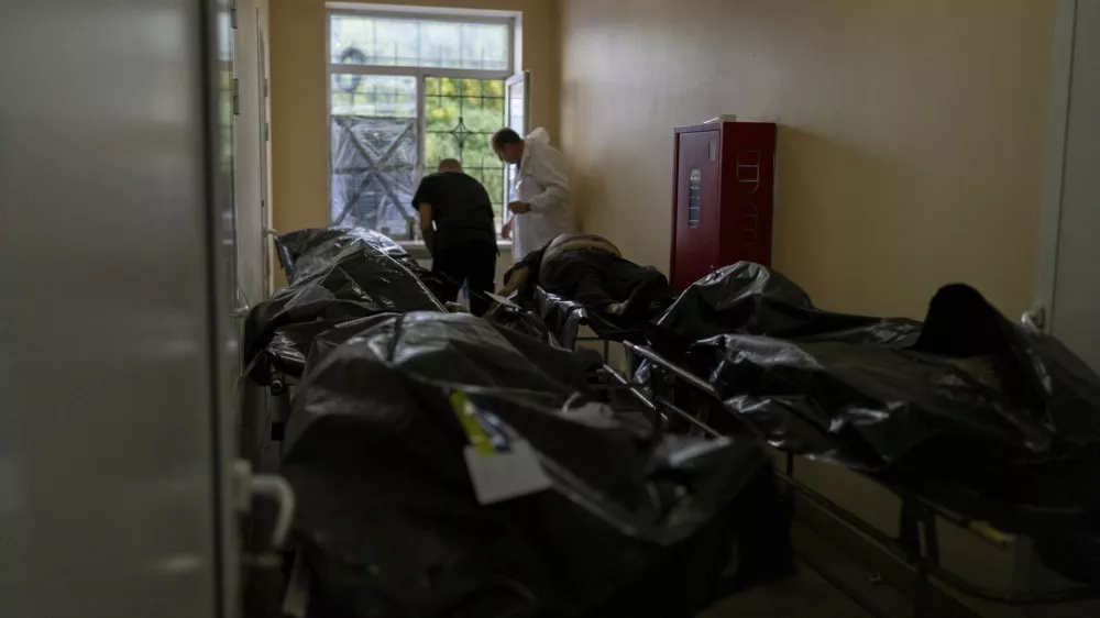Bodies of civilians killed in a Russian aerial attack on village of Yarova, are seen at a morgue in Donetsk region, Tuesday, Sept. 9, 2025. (AP Photo/Alex Babenko)