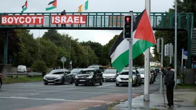 Pro-Palestinian protestors hold flags and a sign on a motorway overpass outside the RTE (Radio Telefis Eireann) Irish public service broadcaster television studios, in Dublin, Ireland, September 11, 2025. REUTERS/Clodagh Kilcoyne