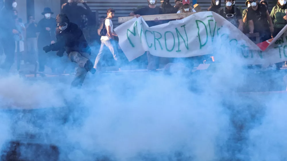 A demonstrator kicks away a tear gas canister as people gather to block traffic at a roundabout at Pres d'Arenes in Montpellier, as part of a grassroots protest movement called "Bloquons Tout" ("Let's Block Everything") calling for nationwide all-day disruption, France, September 10, 2025. REUTERS/Manon Cruz