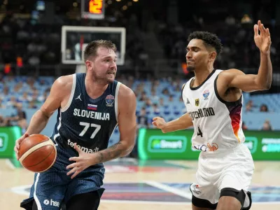 Basketball - FIBA EuroBasket 2025 - Quarter Finals - Germany v Slovenia - Xiaomi Arena, Riga, Latvia - September 10, 2025 Slovenia's Luka Doncic in action with Germany's Maodo Lo REUTERS/Ints Kalnins