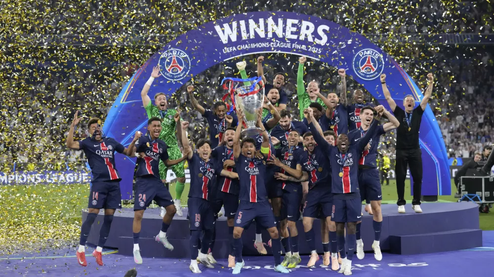 PSG players celebrate with the trophy after winning the Champions League final soccer match between Paris Saint-Germain and Inter Milan at the Allianz Arena in Munich, Germany, Saturday, May 31, 2025. (AP Photo/Matthias Schrader)