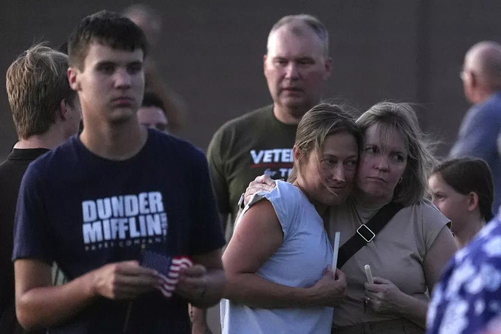 Well-wishers attend a Catholic rosary prayer vigil after Charlie Kirk was shot and killed during a Utah college event Wednesday, Sept. 10, 2025, in Scottsdale, Ariz. (AP Photo/Ross D. Franklin)