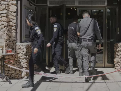 Members of the Israeli security forces work at the scene of a stabbing attack at a hotel in the Kibbutz Tzova, outside Jerusalem, Friday, Sept. 12, 2025. (AP Photo/Mahmoud Illean)