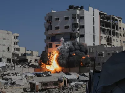 Smoke and flames rise from an Israeli military strike on a building in Gaza City, Friday, Sept. 12, 2025. (AP Photo/Yousef Al Zanoun)