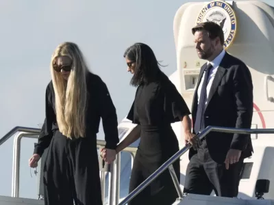 Vice President JD Vance, right, Second Lady Usha Vance, center, and Erika Kirk, holding a cross on a chain, deplane Air Force Two, carrying the body of Charlie Kirk, the CEO and co-founder of Turning Point USA, Thursday, Sept. 11, 2025, in Phoenix, who was shot and killed on Wednesday. AP Photo/(Ross D. Franklin)