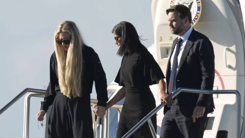 Vice President JD Vance, right, Second Lady Usha Vance, center, and Erika Kirk, holding a cross on a chain, deplane Air Force Two, carrying the body of Charlie Kirk, the CEO and co-founder of Turning Point USA, Thursday, Sept. 11, 2025, in Phoenix, who was shot and killed on Wednesday. AP Photo/(Ross D. Franklin)