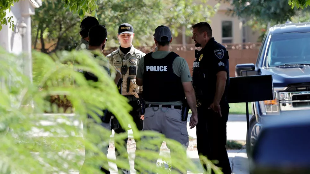 A Washington County sheriff's deputy joins Washington City police officers outside a residence in Washington, Utah, associated with Tyler Robinson, the suspect in the fatal shooting of U.S. conservative commentator Charlie Kirk during an event at Utah Valley University, U.S., September 12, 2025. REUTERS/Steve Marcus