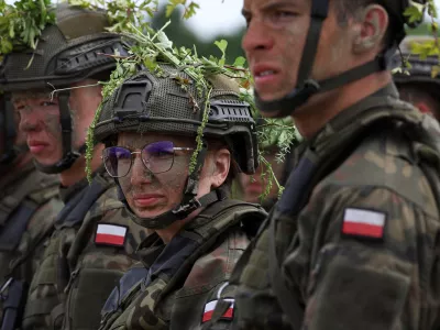 Thirty six-year-old administrator Agnieszka Jedruszak stands with other recruits during voluntary military training at the training ground in Braniewo, Poland, June 24, 2025. REUTERS/Kacper Pempel