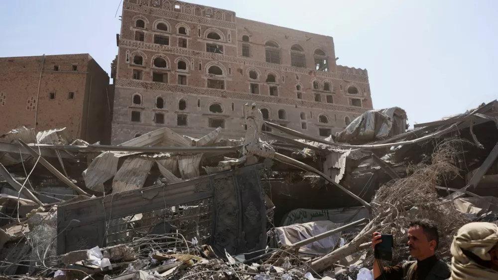A member of the media uses a mobile phone to film at the site of Wednesday's Israeli airstrikes, in Sanaa, Yemen September 14, 2025. REUTERS/Khaled Abdullah
