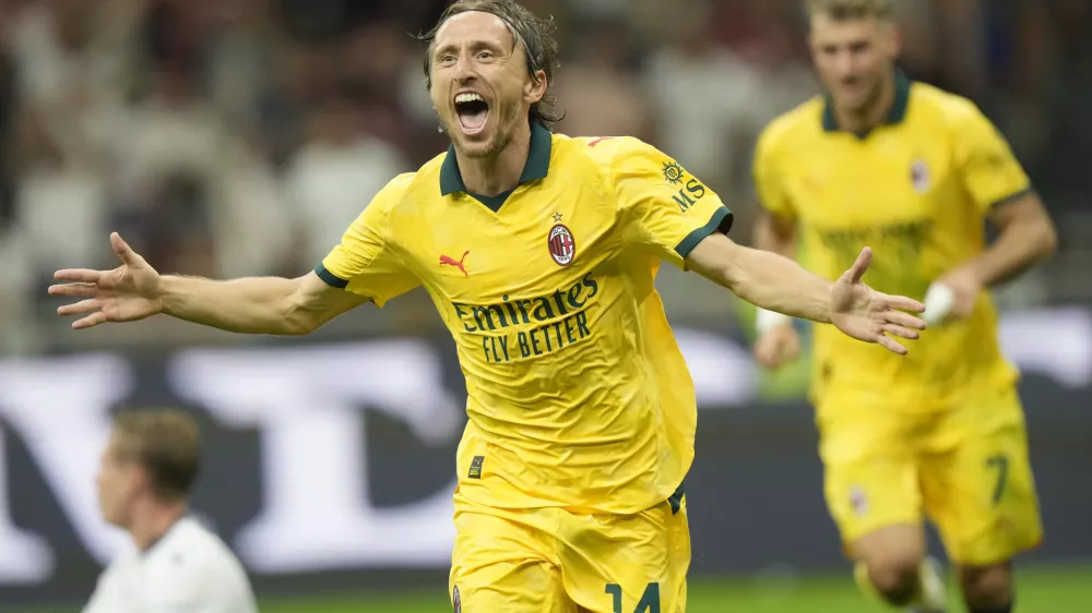 AC Milan's Luka Modric celebrates after scoring his side's opening goal during a Serie A soccer match between AC Milan and Bologna at San Siro stadium in Milan, Italy, Sunday, Sept. 14, 2025. (AP Photo/Luca Bruno)